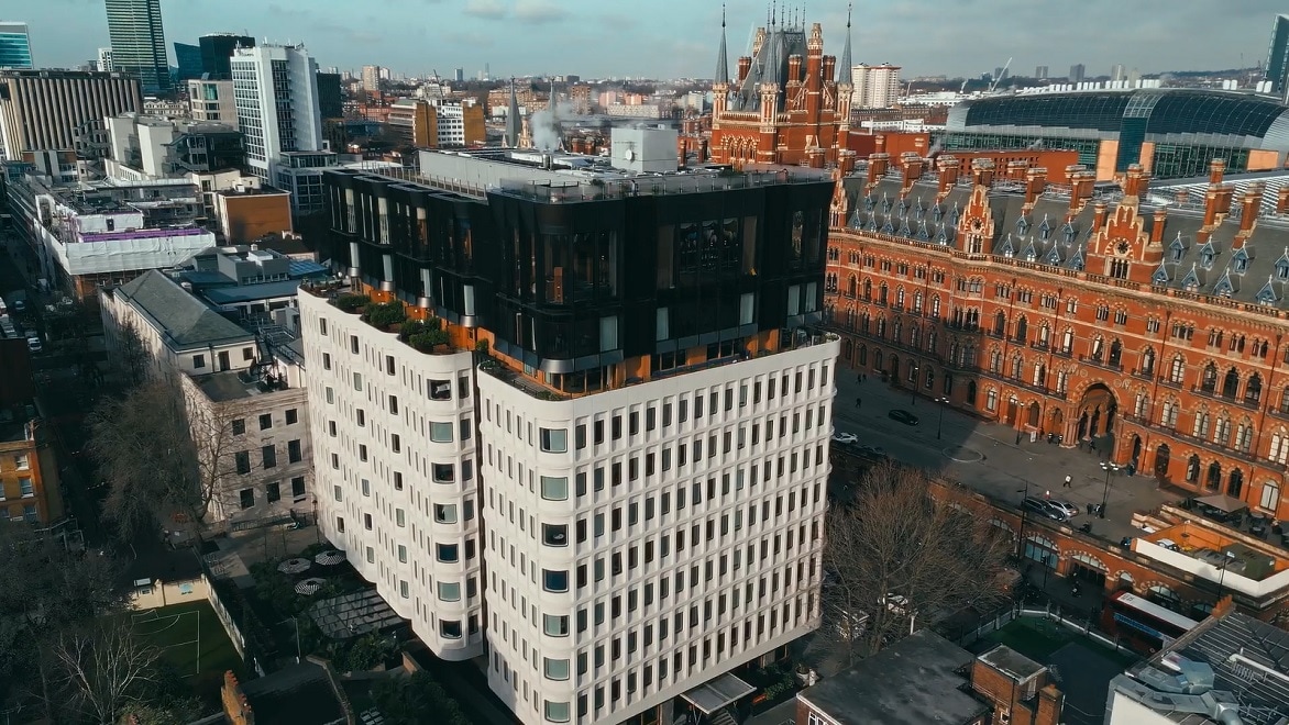 Aerial view of The Standard London, a repurposed 1970s building situated next to the Victorian Gothic St. Pancras railway station.